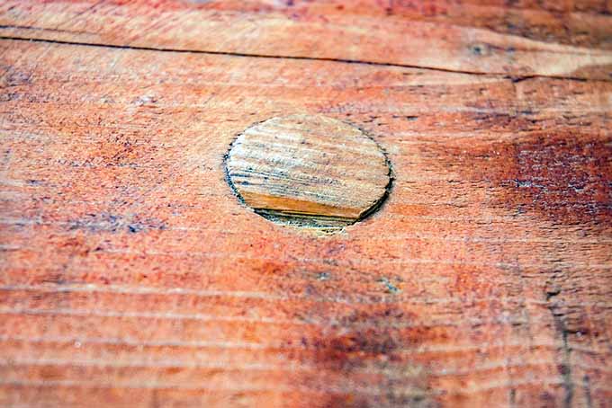 A close up of a piece of redwood, a common wood used in playground sets.