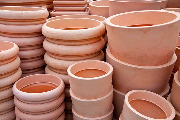 Closeup of several stacks of terra cotta containers, each very clean and new.