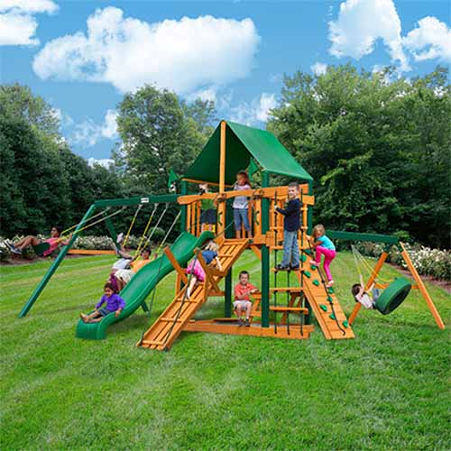 Gorilla Playsets Frontier backyard swing and climbing set on a lawn in a sunny garden.