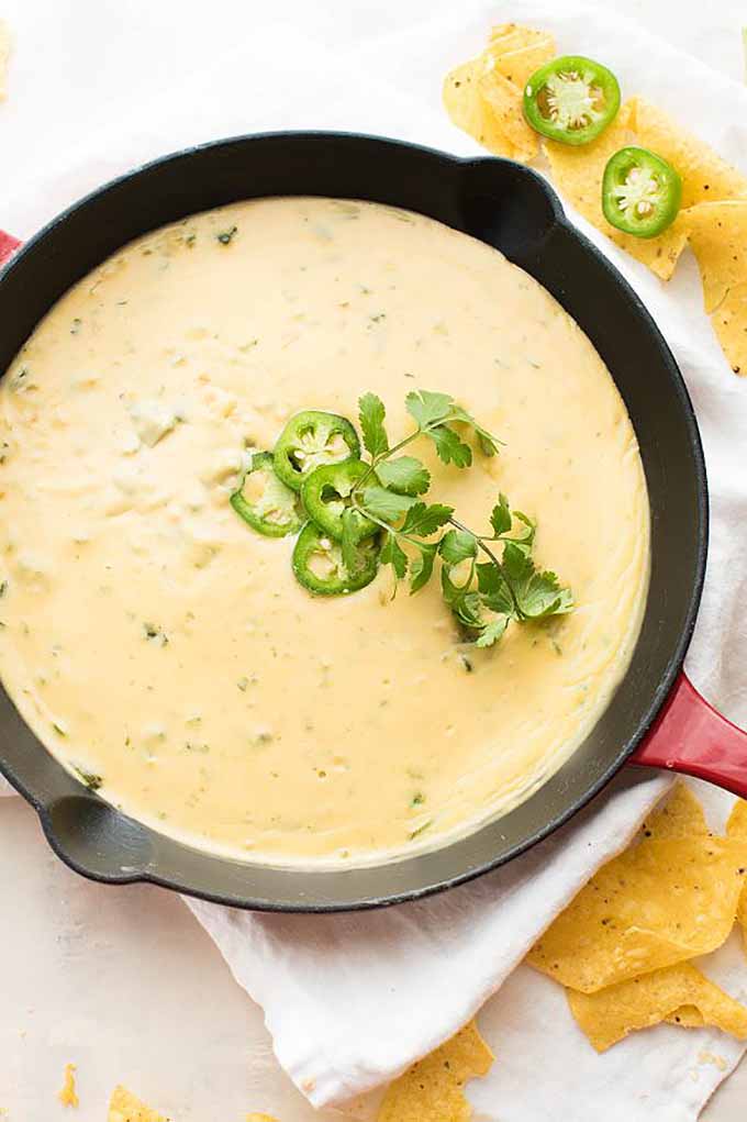 Roasted poblano queso dip is delicious when it's made with homegrown peppers. We share more of or favorite hot pepper recipes, and tips for growing them- read more now on Gardener's Path or Pin It for later!