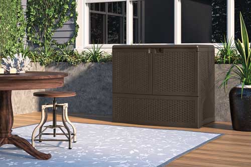 Suncast Backyard Oasis Storage and Entertaining Station on a back wooden deck set up as an outdoor room.