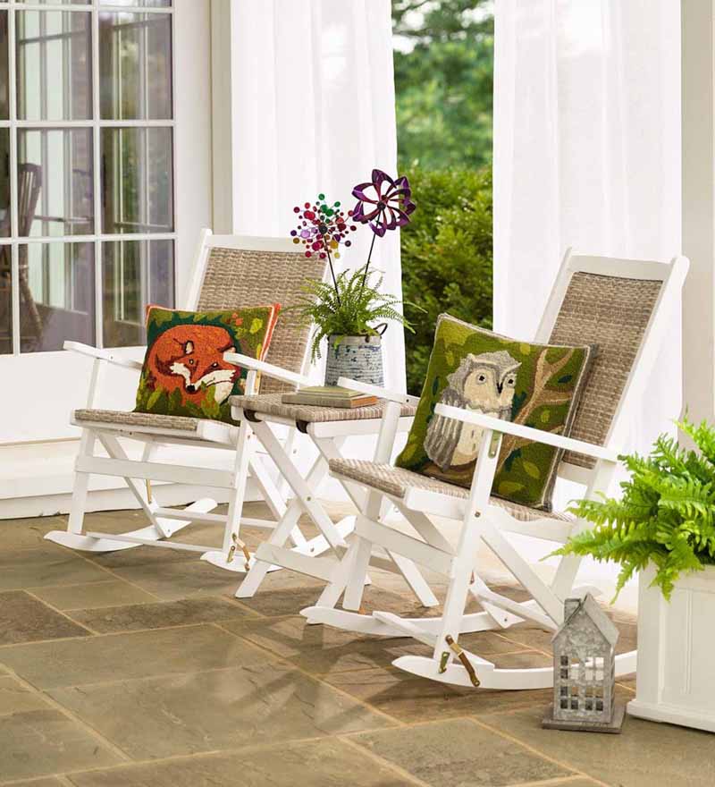 Claytor Folding Eucalyptus Outdoor Furniture, Two Rockers and Side Table in white on a stone tiled porch.