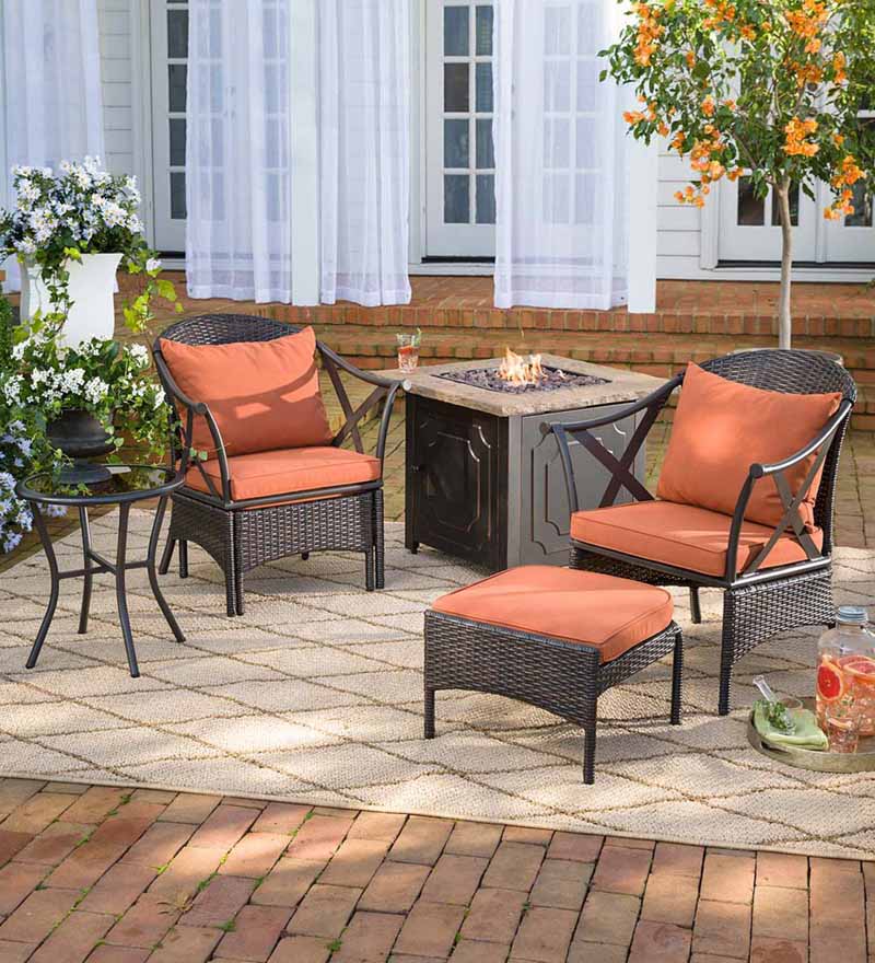 Plow and Earth Wicker Patio Furniture Set on a tiled and brick backyard patio.