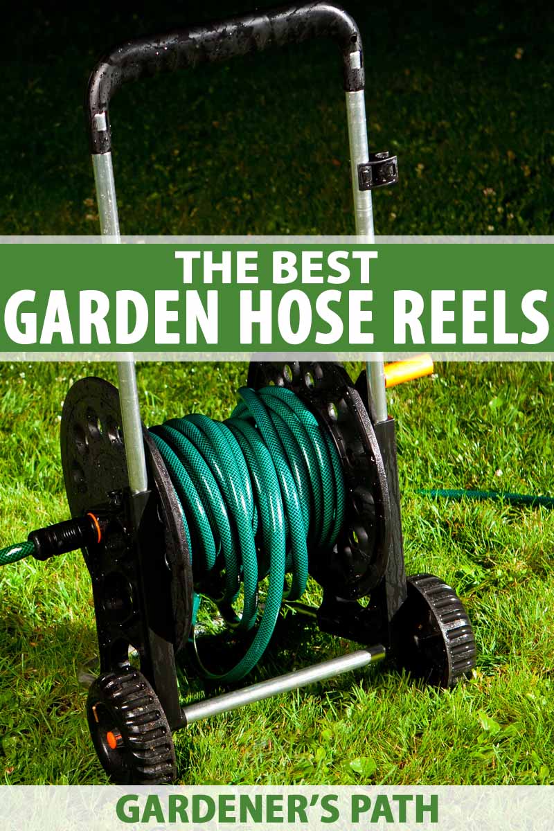 A wheeled garden hose reel on a green lawn at night.