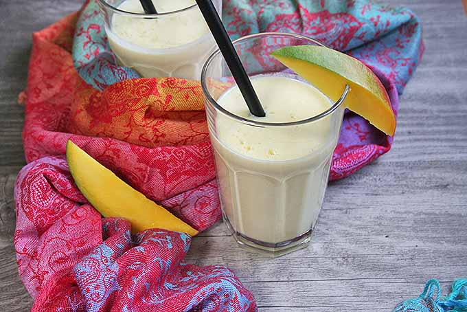Cool and creamy Indian lassi on a wooden table.