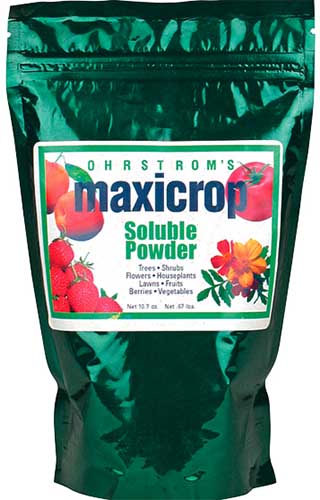 A close up of the packaging of Maxicrop Soluble Powder Fertilizer on a white background.