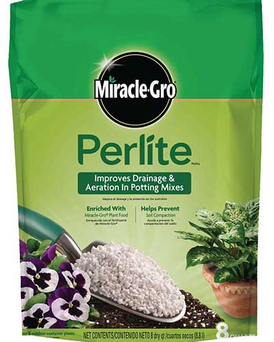 A close up of the green and white packaging for Miracle-Gro Perlite on a white background.