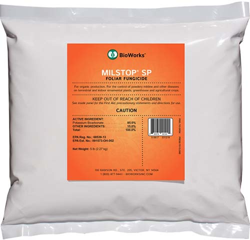 A close up square image of a small white plastic bag containing Milstop foliar fungicide for treating powdery mildew on plants.