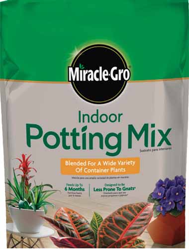 A close up of the packaging of MiracleGro Indoor Potting Mix on a white background.