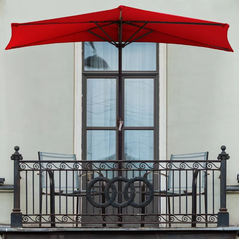 Red half umbrella on a small balcony. 