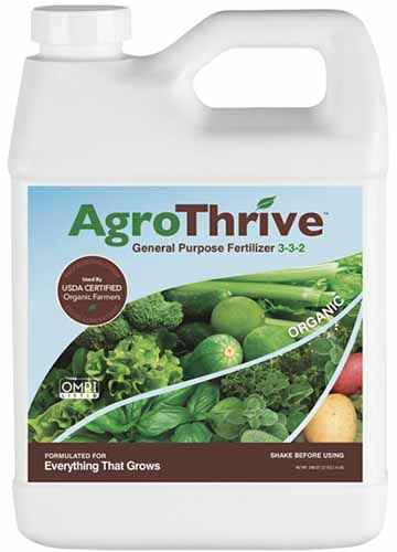 A close up square image of a plastic bottle of AgroThrive General Purpose Fertilizer isolated on a white background.
