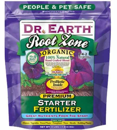 A close up vertical image of the packaging of Dr Earth's Root Zone Organic Premium Starter Fertilizer isolated on a white background.