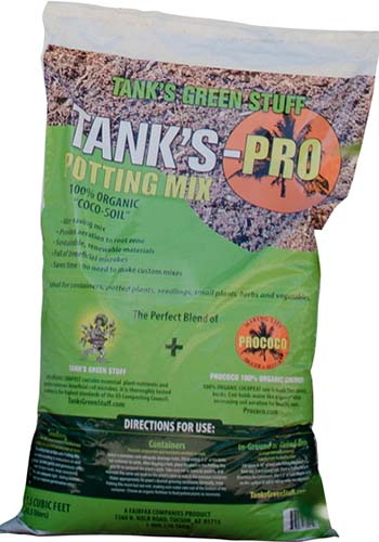 A close up vertical image of a bag of Tank's-Pro Potting Mix isolated on a white background.