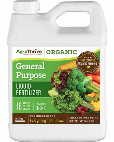 A close up square image of a plastic bottle of AgroThrive General Purpose Liquid Fertilizer isolated on a white background.