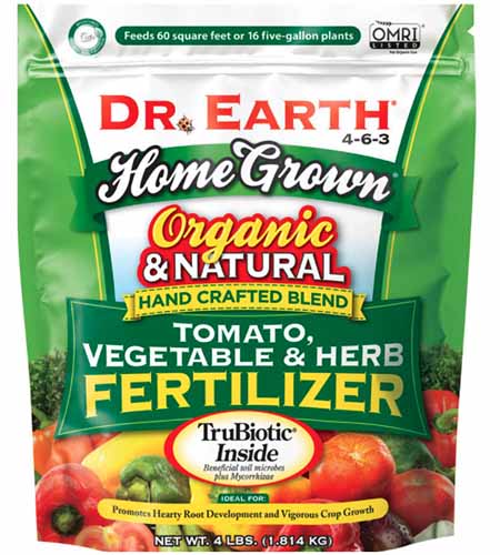 A close up square image of the packaging of Dr. Earth Organic and Natural Tomato, Vegetable, and Herb Fertilizer isolated on a white background.