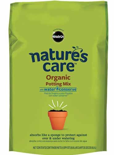 A close up vertical image of the packaging of MiracleGro Nature's Care Organic Potting Mix isolated on a white background.