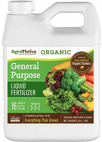 A close up vertical image of a plastic bottle of AgroThrive Organic General Purpose Liquid Fertilizer isolated on a white background.