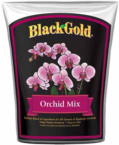 A close up vertical image of a bag of Black Gold Orchid Mix isolated on a white background.
