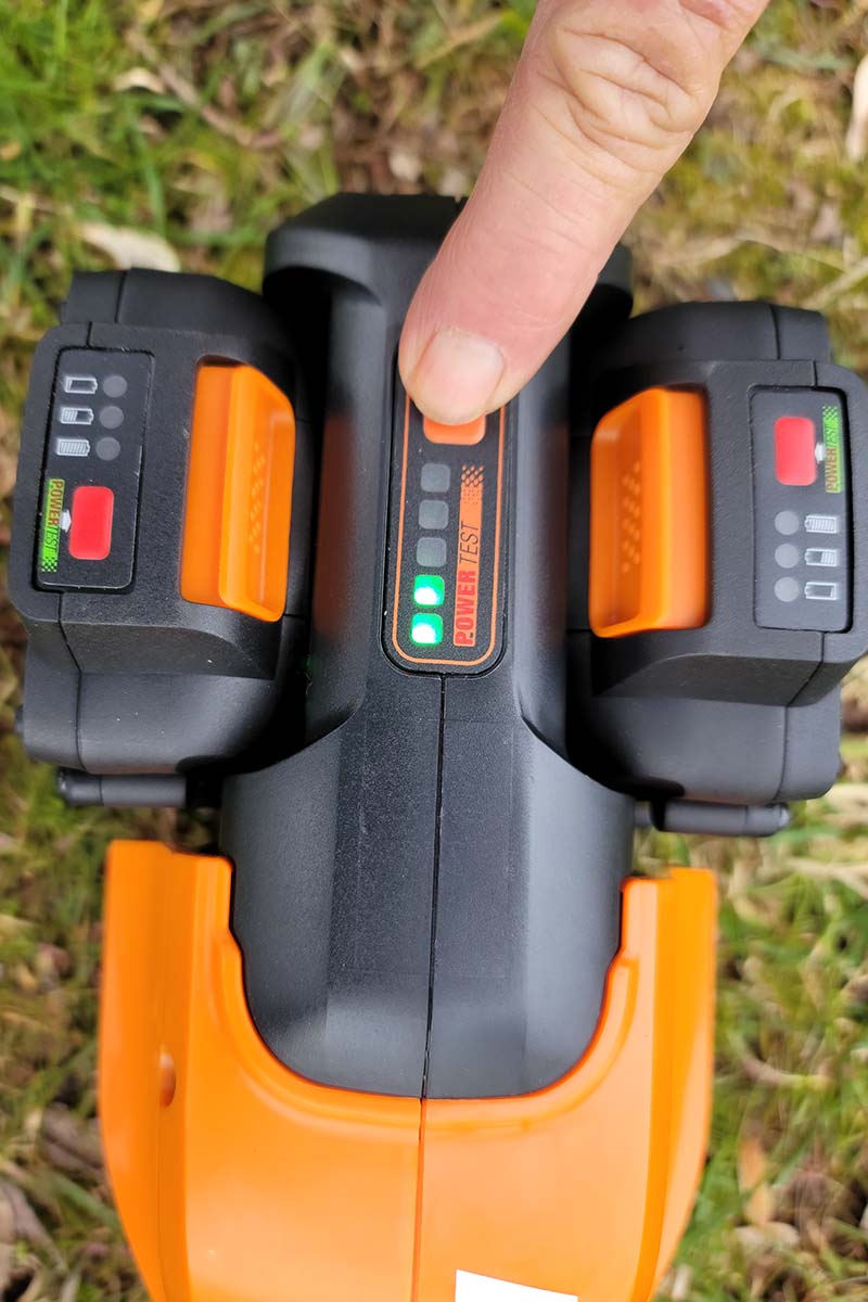A close up vertical image of battery test lights on a Worx WG184 lawn edger and trimmer.