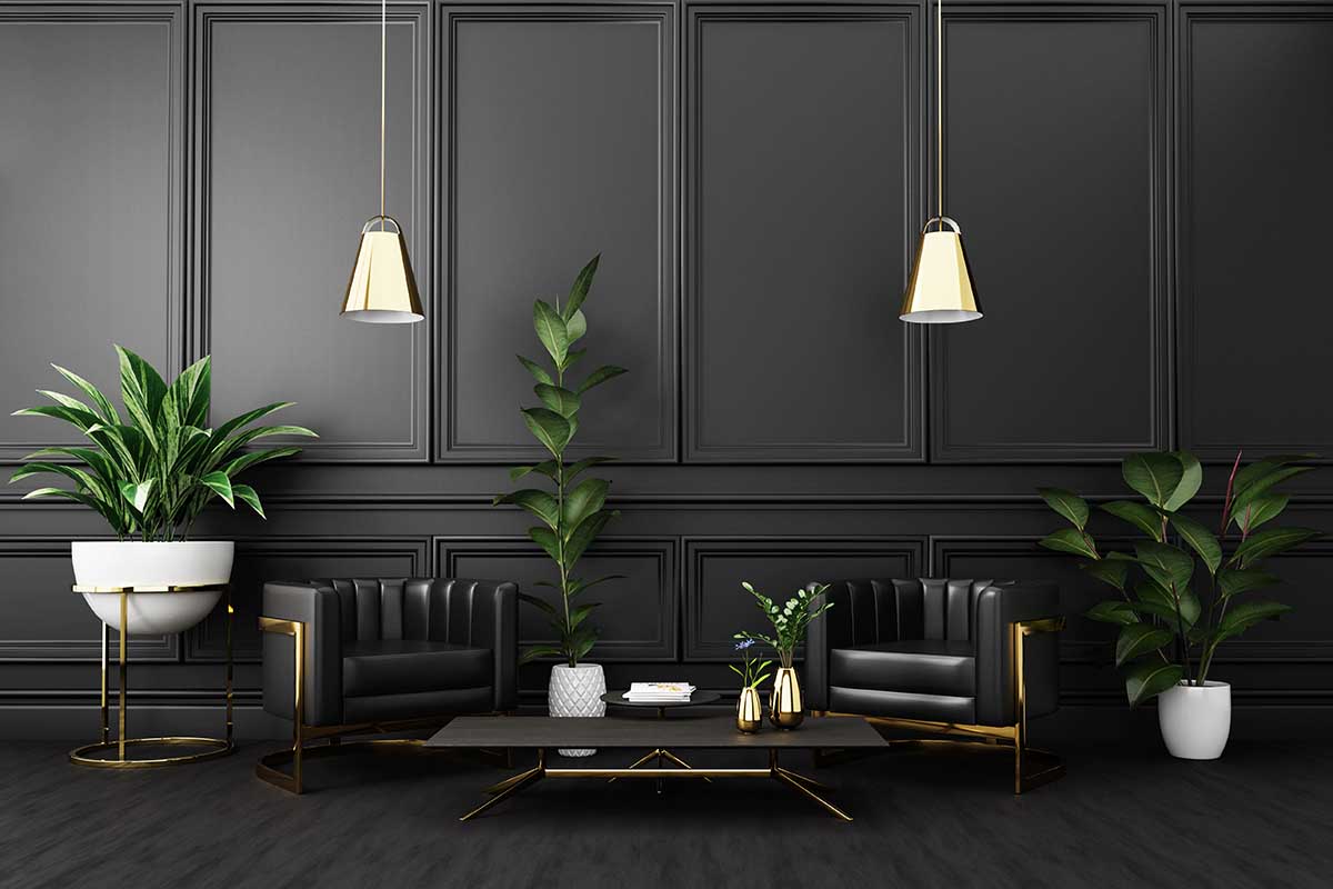 A horizontal picture of an elegant living room with dark gray walls and low lighting.
