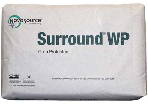 A close up horizontal image of a package of Novasource Surround WP Crop Protectant isolated on a white background.