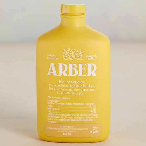 A close up square image of a yellow bottle of Arber Bioinsecticide pictured on a white background.