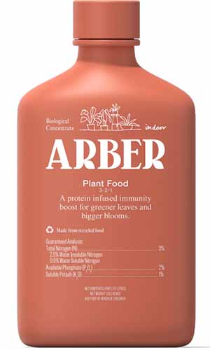 A close up of a bottle of Arber Plant Food isolated on a white background looking lonely.