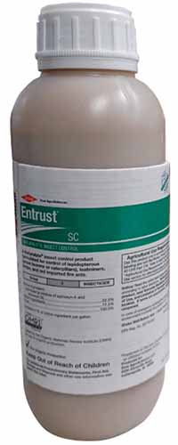 A close up of a bottle of Entrust SC Naturalyte Insect Control isolated on a white background.