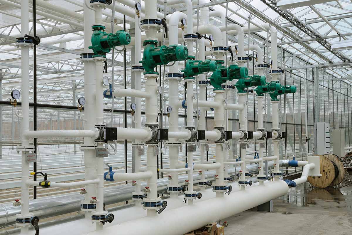 A horizontal image of a large pipe system for heating a commercial glasshouse.