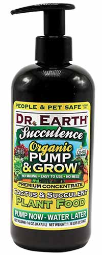 A close up vertical image of a pump bottle of Dr Earth Succulence Organic Pump and Grow Plant Food isolated on a white background.