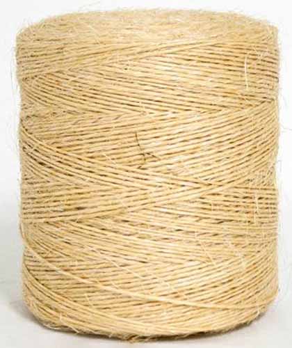 A close up of a roll of sisal binder twine isolated on a white background.