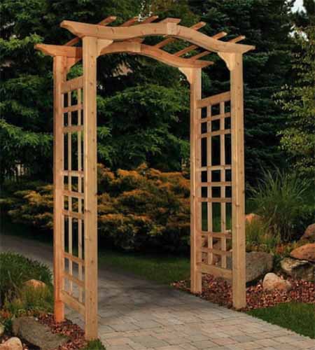 A close up square image of a wooden arbor over a garden pathway.