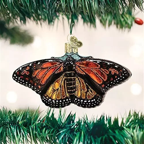 A close up of a hanging Monarch ornament attached to a Christmas tree.