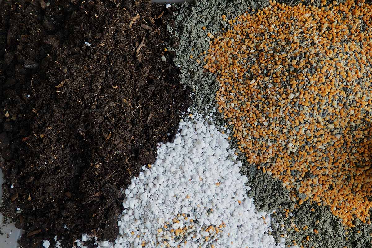 A close up horizontal image of the ingredients ready to mixed into the perfect succulent potting soil.