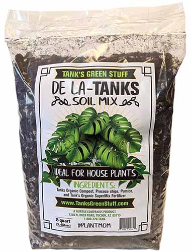 A close up of the packaging of Tank's Green Stuff De La-Tanks Soil Mix isolated on a white background.