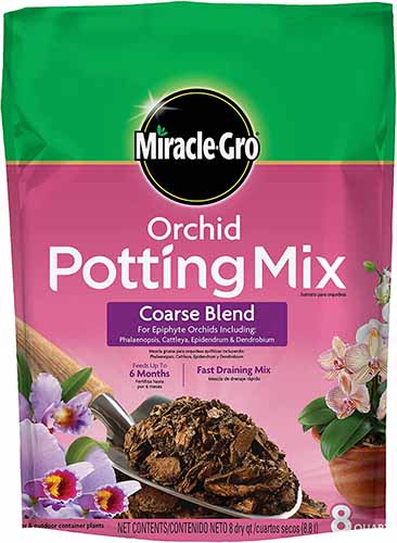 A close up of the packaging of MiracleGro Orchid Potting Mix isolated on a white background.