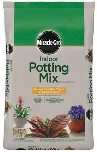 A close up of the packaging of Miracle-Gro Indoor Potting Mix isolated on a white background.
