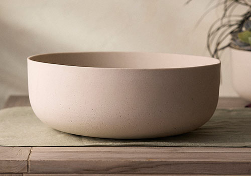 A close up of a wide planter bowl set on a countertop.