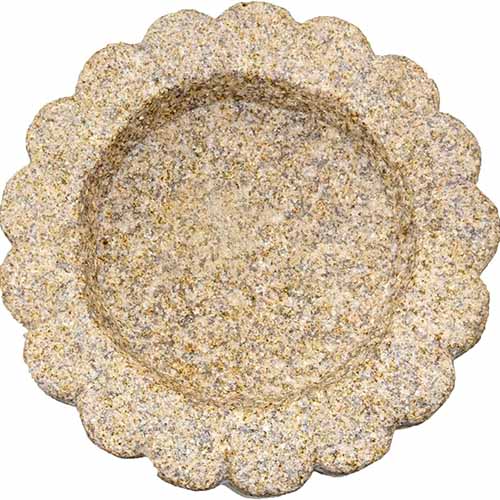A close up of the Crabby Nook granite birdbath isolated on a white background.