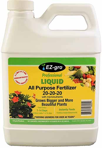 A close up of a plastic bottle of EZ Grow All Purpose fertilizer isolated on a white background.