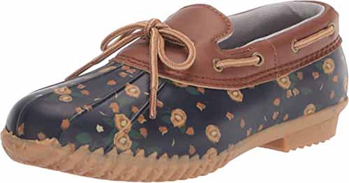 A close up of a Jambu Women's Gwen Garden Ready Duck Shoe in Whiskey Navy floral isolated on a white background.