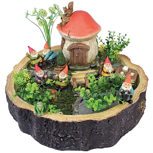 A close up square image of a garden gnomes fairy garden pictured on a white background.