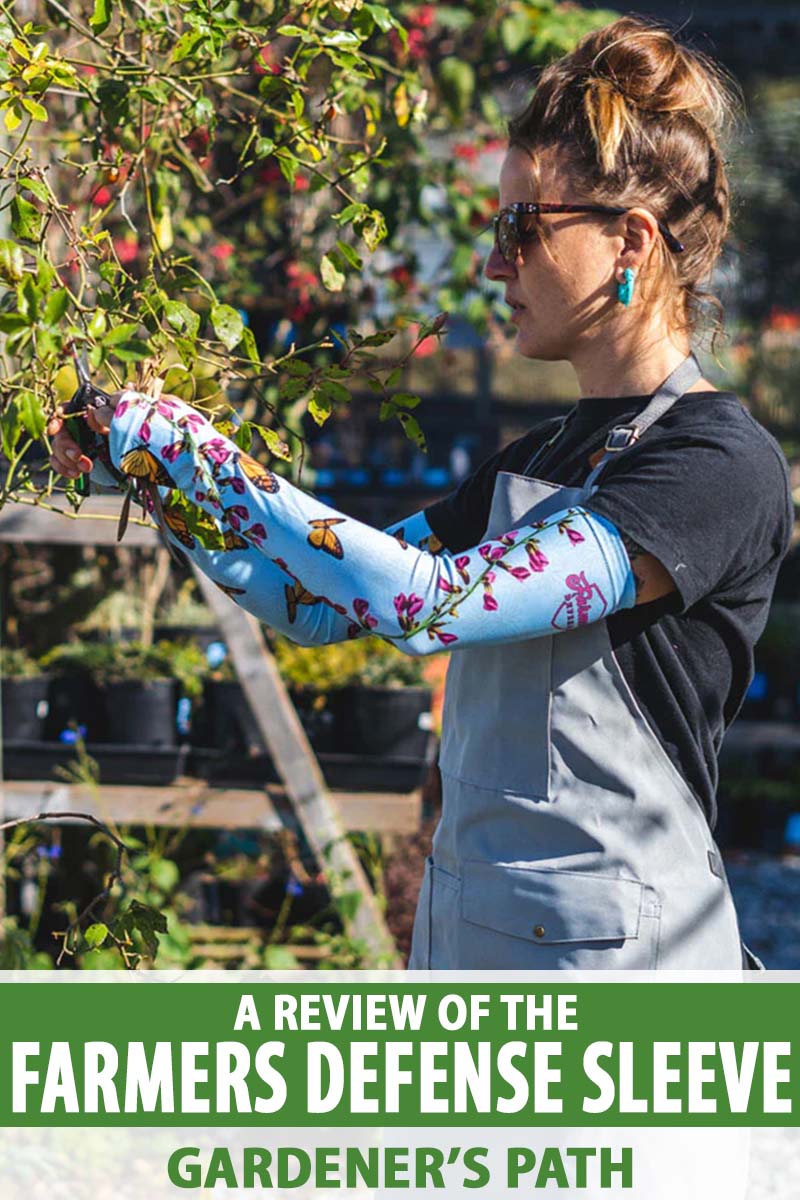 A close up vertical image of a woman wearing Farmers Defense Sleeves and working in the garden pictured in light sunshine. To the bottom of the frame is green and white printed text.