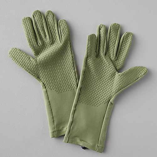 A square image of green Second Skin gloves pictured on a gray background.