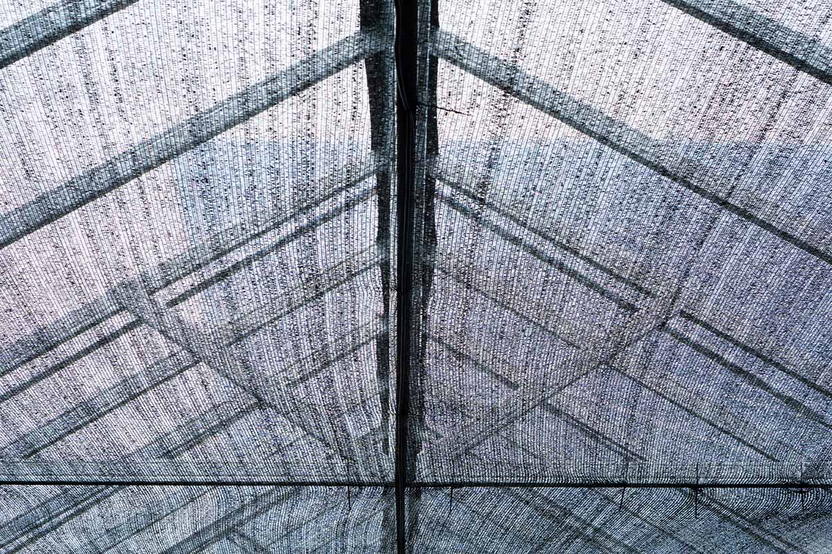 A close up of shade cloth used on the roof of a greenhouse.