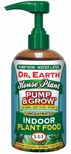 A close up of a bottle of Dr Earth Pump & Grow Houseplant food isolated on a white background.