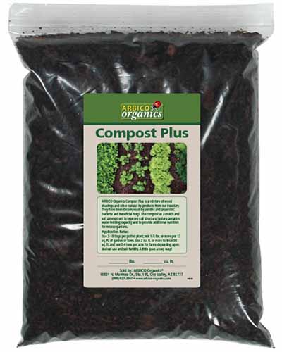 A close up of a bag of Compost Plus isolated on a white background.