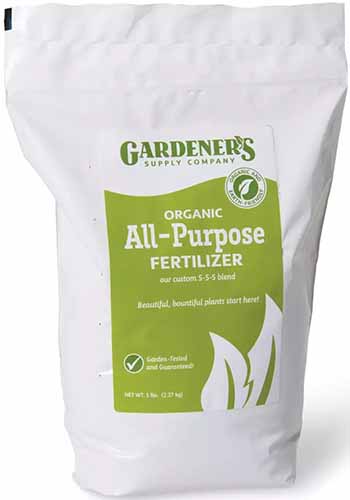 A close up of a bag of Gardener's Supply Company Organic All Purpose Fertilizer isolated on a white background.
