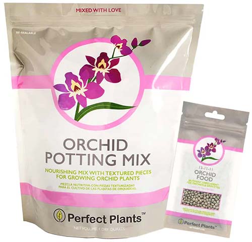 A close up of the packaging of Perfect Plants All-Natural Orchid Potting Mix, with a small packet of fertilizer to the right of the frame.