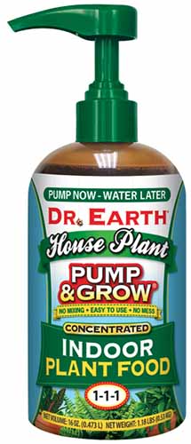 A close up of a bottle of Dr Earth Pump and Grow Houseplant Fertilizer isolated on a white background.